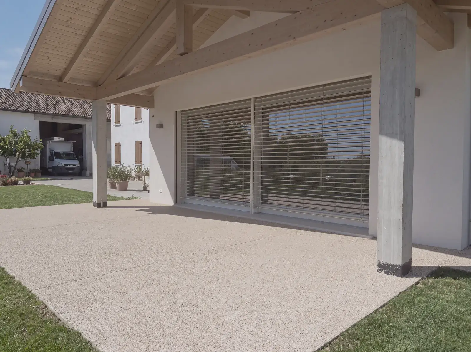 Portico in Sassoitalia affacciato sul giardino di una casa di nuova costruzione a Guastalla (RE)